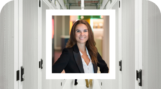 Amelia Bengtsson, Growth principal in London, wearing a white shirt and black blazer, smiling directly in the camera , her photo is inside a white bordered frame set against the background of a hall with white cupboards on the side, giving a 3D effect