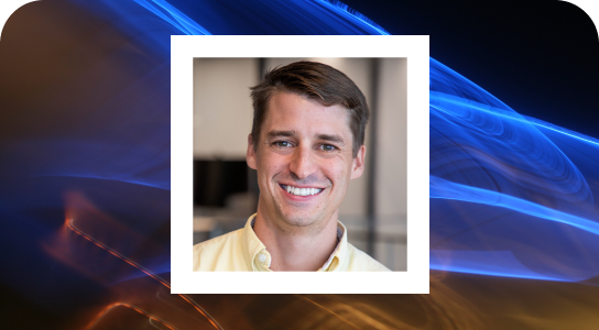 Max Struever, principle-engineer in New York, wearing a yellow shirt, smiling directly into the camera, his photgraph is inside a white bordered phrame set against the background blue light streaks 