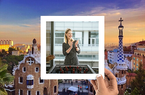 A hand holds a photo of four smiling people taking a selfie, with a vibrant city nightscape in the background.