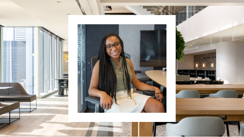 A photo of a smiling woman, seated comfortably in a modern office lounge area, with a stylish interior and city view through large windows.