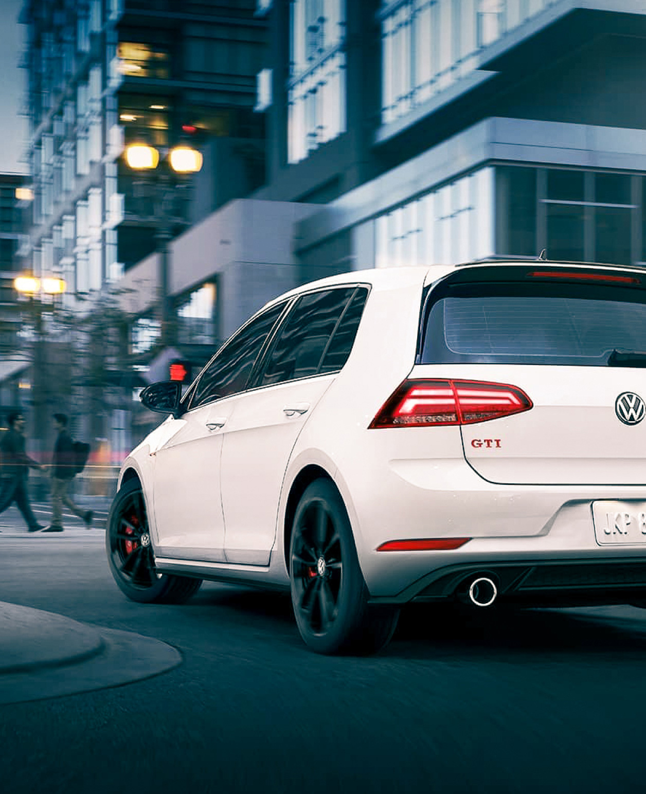 The rear view of a white Volkswagen Golf GTS navigating a lively city street, highlighting its modern aesthetic and urban vibe.